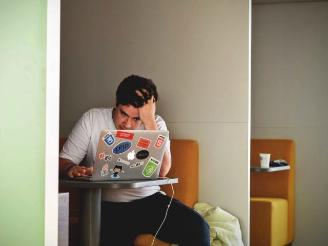 frustrated man using a laptop