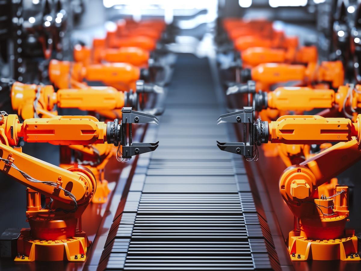 Robotic arms along assembly line in modern factory