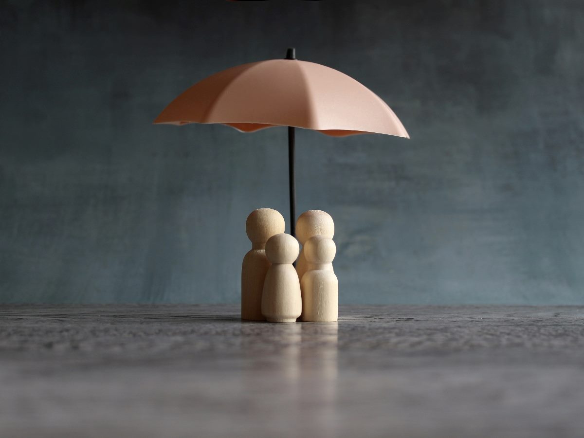Umbrella and wooden dolls holding the umbrella.