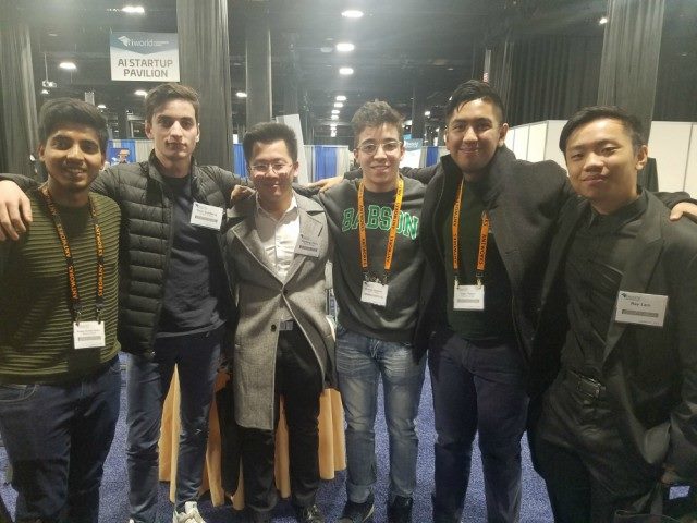 Six Babson College Students lined up, arms around one another, at the AI World Conference & Exhibition Center.