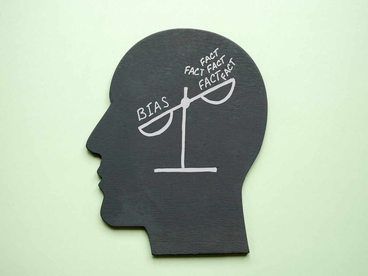 Scales in a head with the words "bias" and "facts"