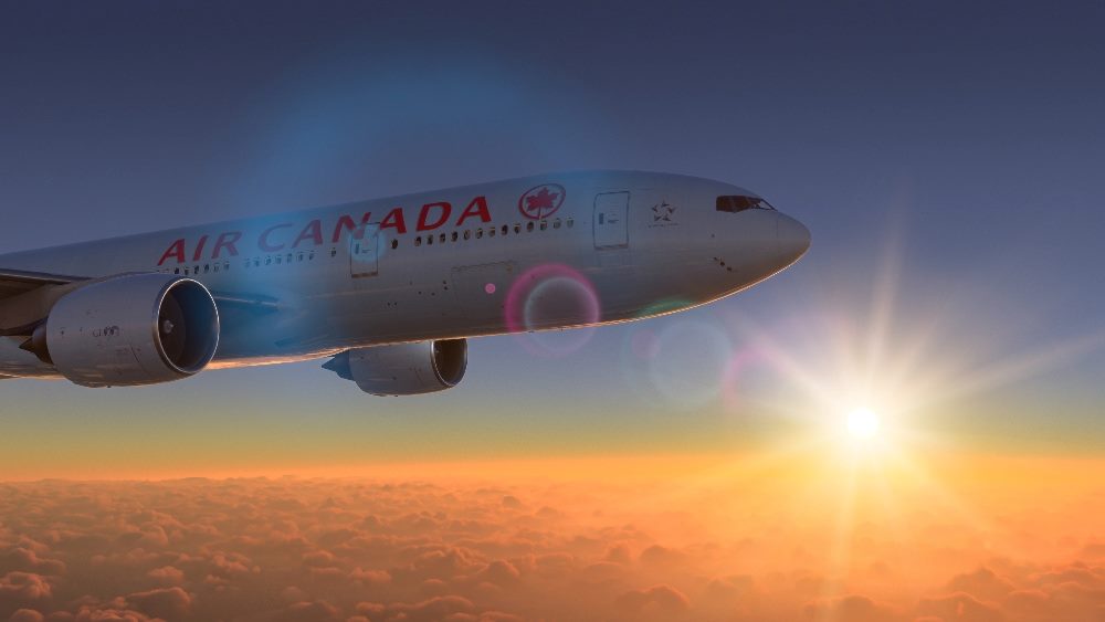 Air Canada plane in flight in the sky.