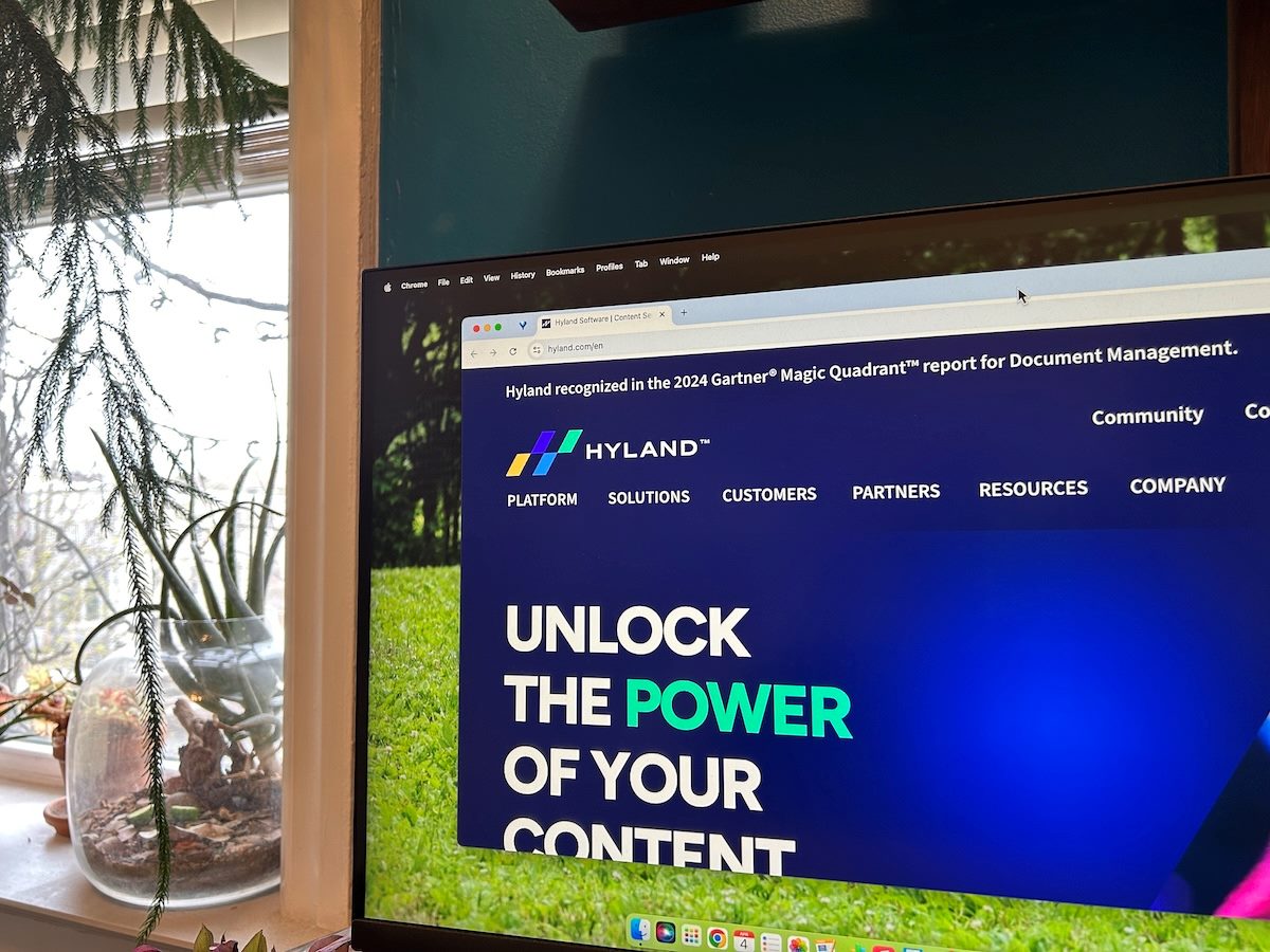 hyland's new website with rebranding visible on an external monitor, a terrarium with beetles visible in the background