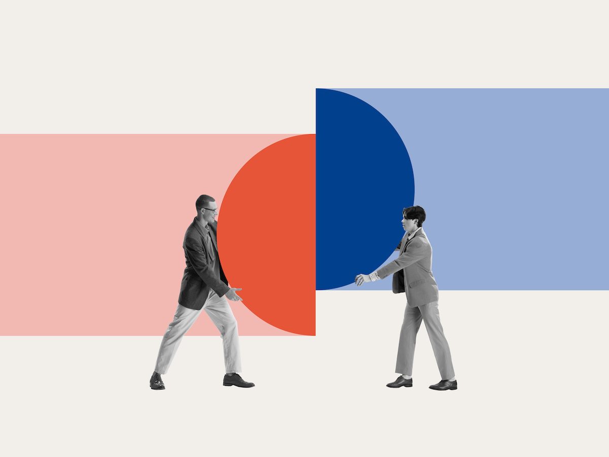 Two businessmen connecting pieces