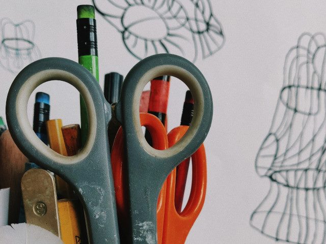 A cup of pencils and scissors.