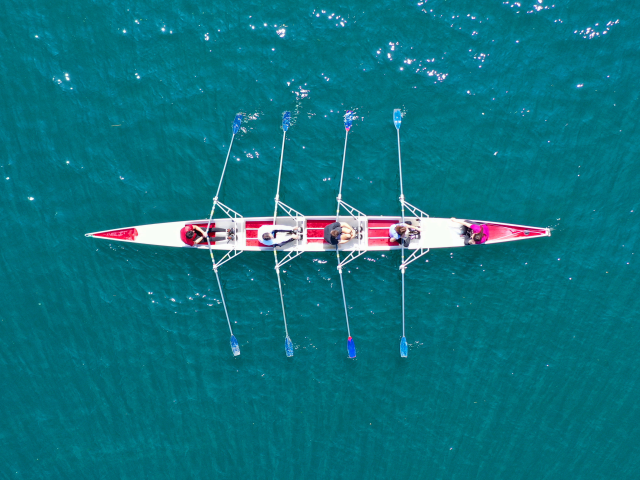Aerial drone top panoramic view of sport canoe rowing synchronous athletes competing