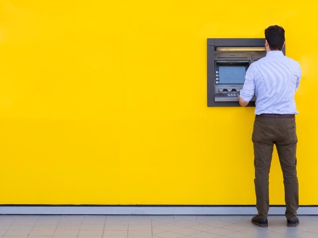 Man withdrawing money from an atm bank machine.
