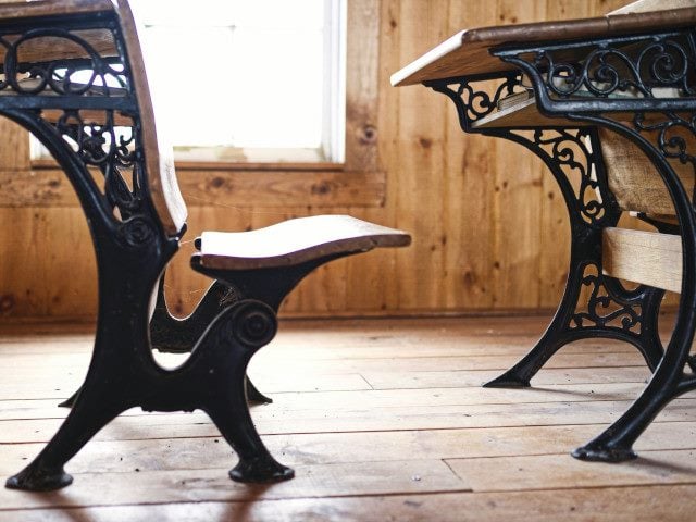 An old school desk in a classroom.