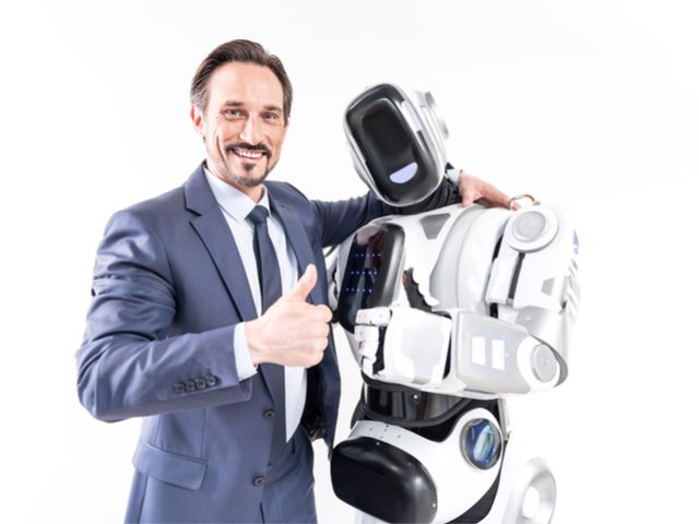 Man giving a thumbs up and hugging an humanoid AI/robot