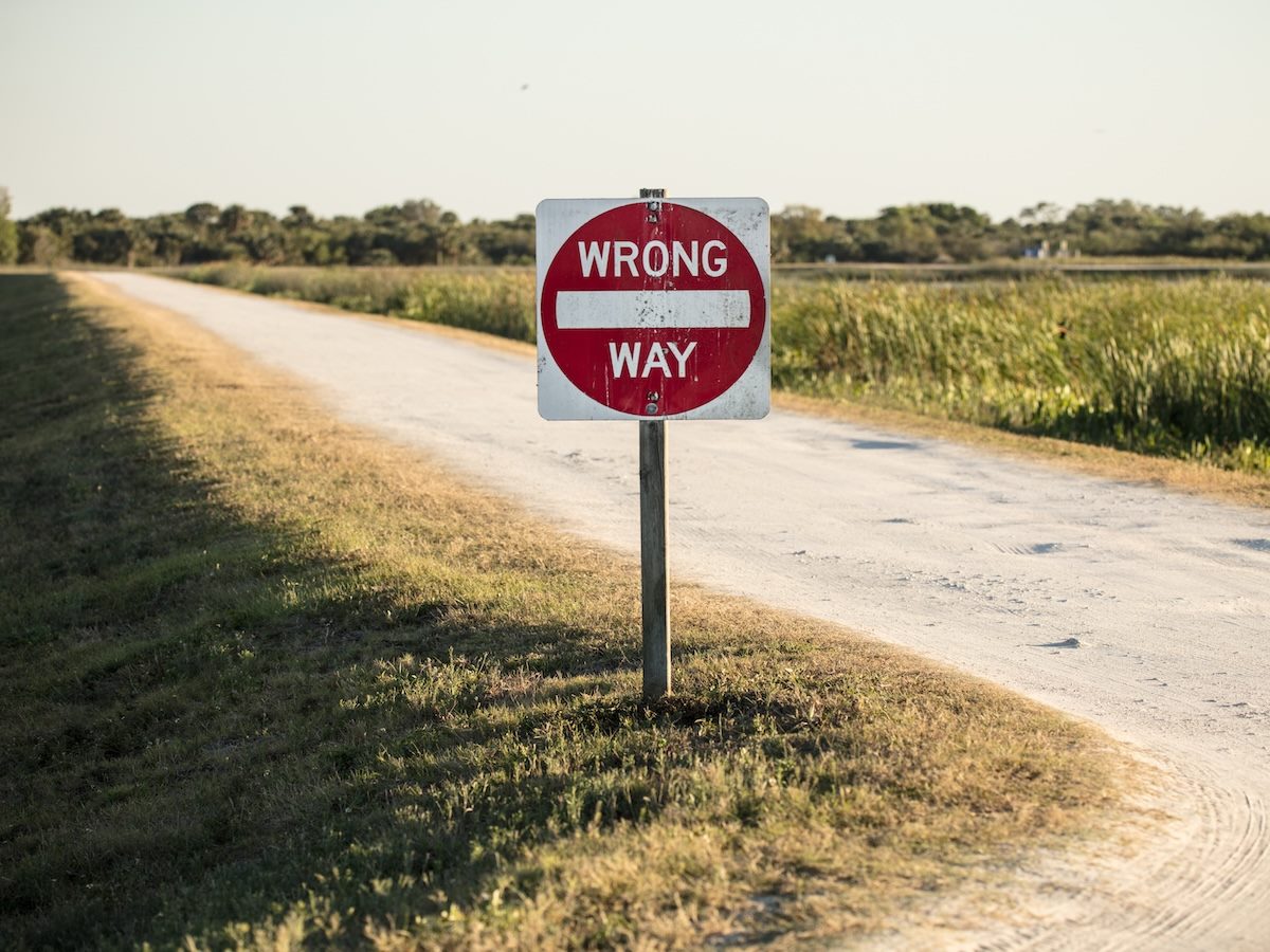 A wrong way road sign