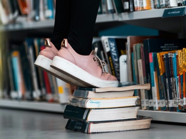 reaching for books on high shelves