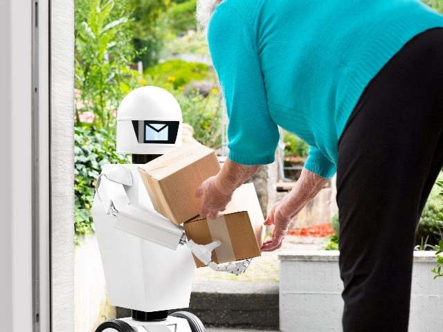 Woman bending down to receive a package from an futuristic robotic delivery service.