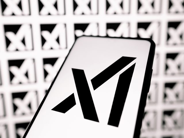 The logo of the newly launched Elon Musk company xAI on a smart phone, with a black on white design on the  phone and white on black in the background.