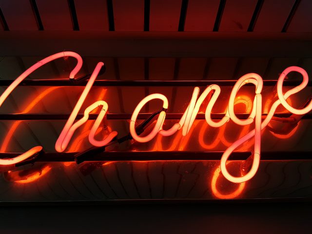 Neon sign reading "change"