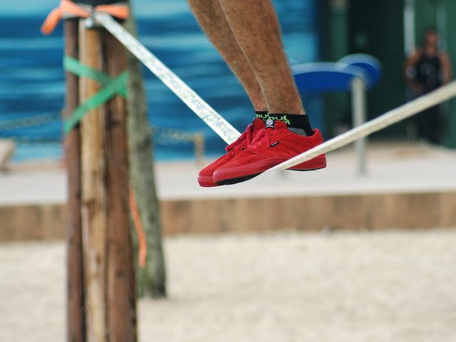 man balancing on tightrope