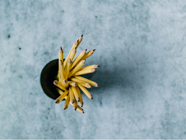 A bunch of pencils stored in a cup.