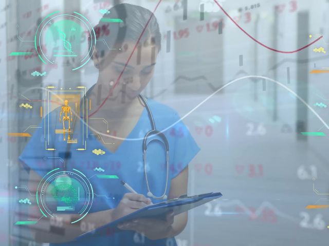 A medical professional standing behind a digital display 