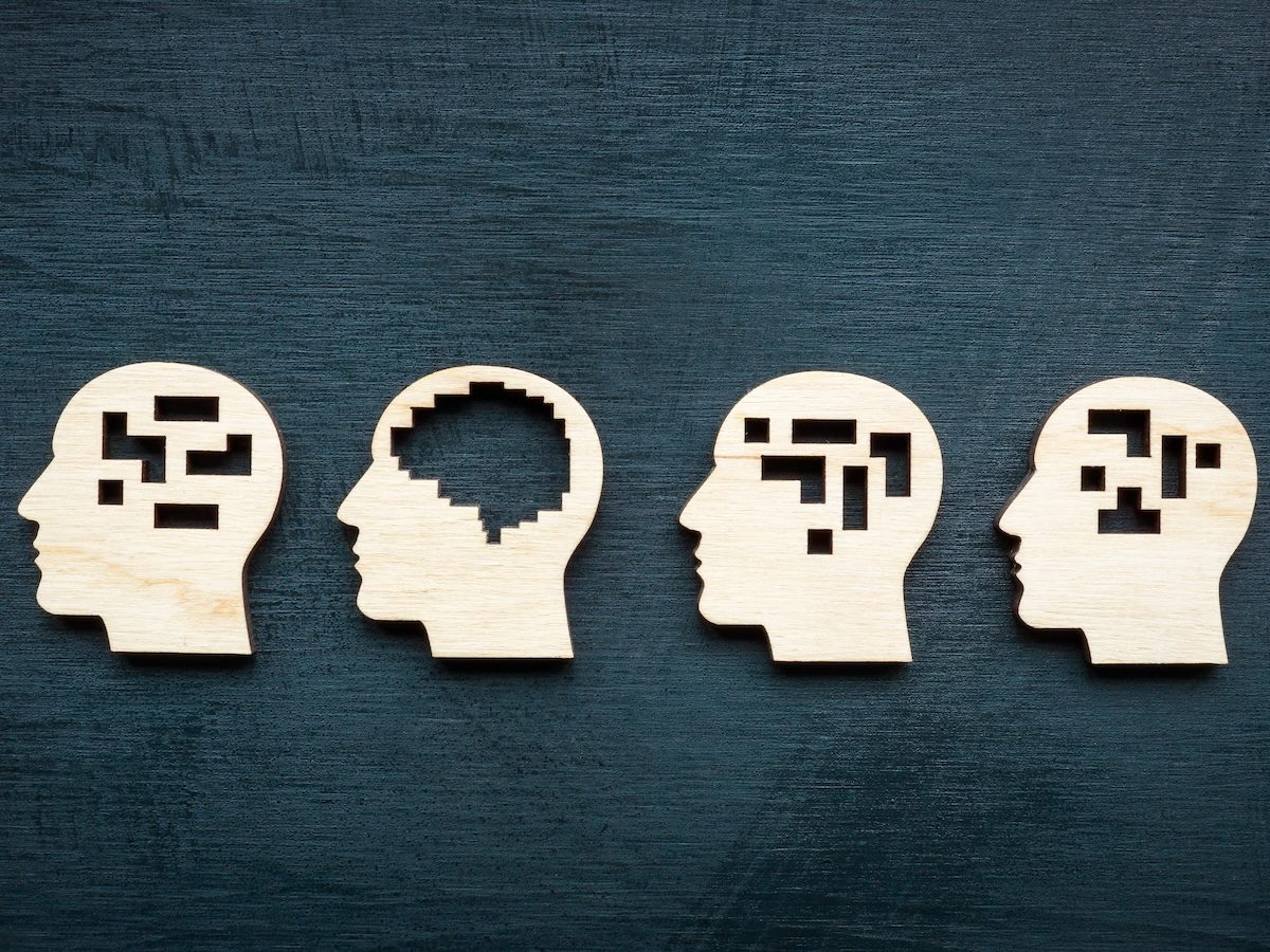 wooden head icons on grey background