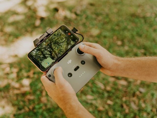 A drone pilot uses a drone controller.