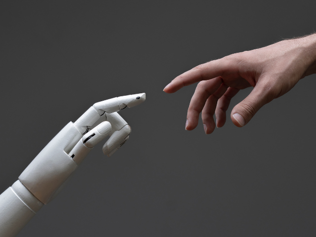 A robot hand touching a human hand