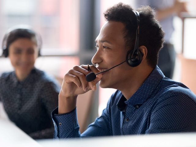 Man working at call center smiling