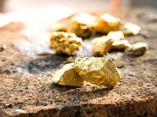 Pure gold found in the mine on a stone floor.
