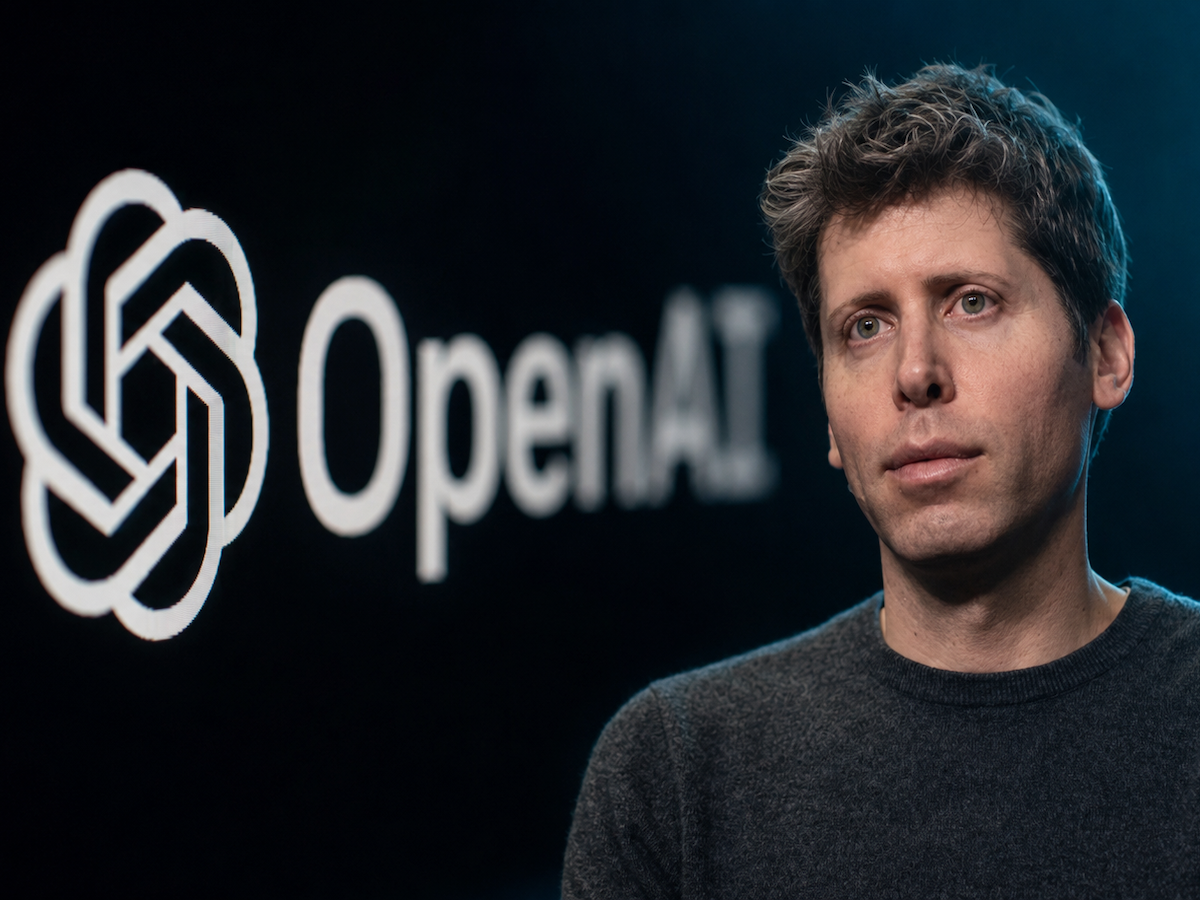 Sam Altman in front of the OpenAI logo