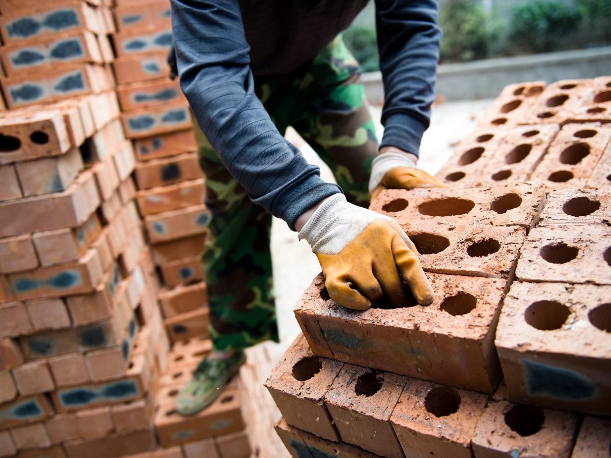 Worker moving bricks.