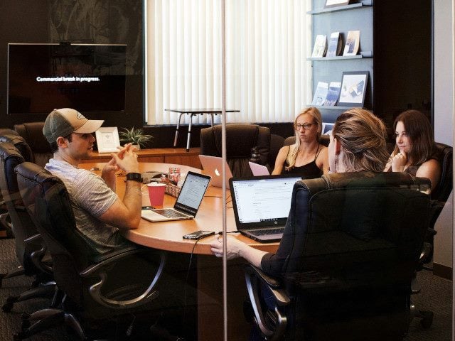 A team of employees meet in a conference room.
