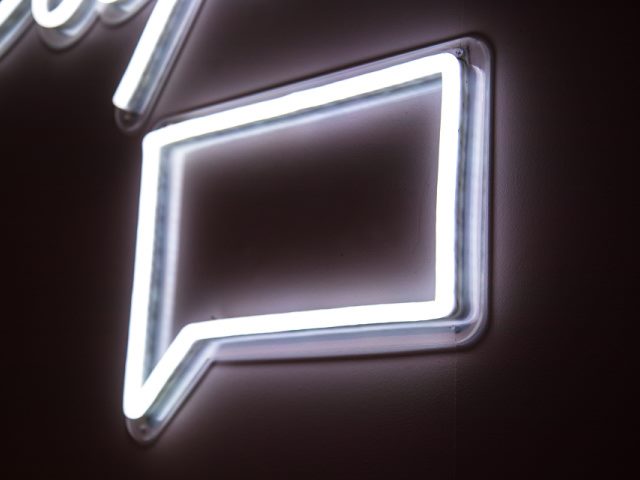 white neon message sign on a black wall