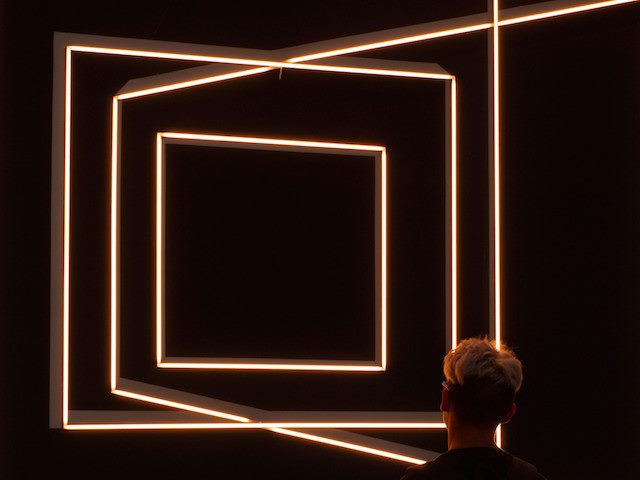 A man in a dark room looking into the future. Digital Workplace concept