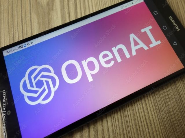 An iPad placed flat on a desk with the words OpenAi displayed