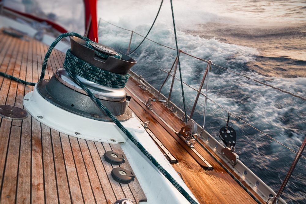 A sailboat being tossed on the sea in a storm a, detail on the winch, in piece about uncertainty of leaders about the AI contact center transformation.