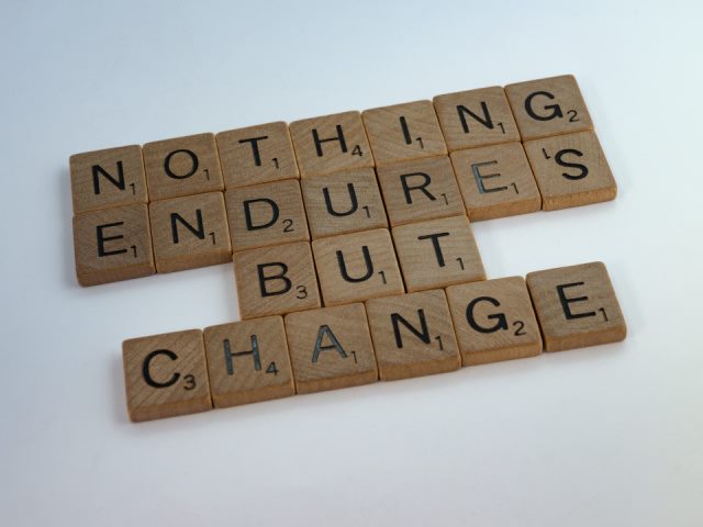 brown Scrabble style tiles on white background with a change message