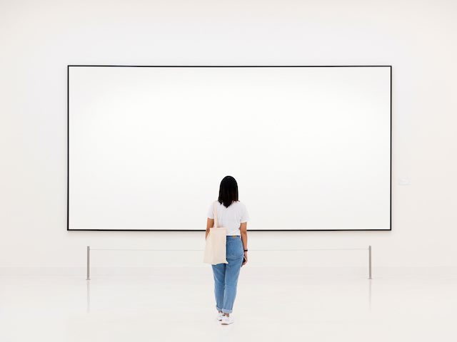 woman looking at blank canvas