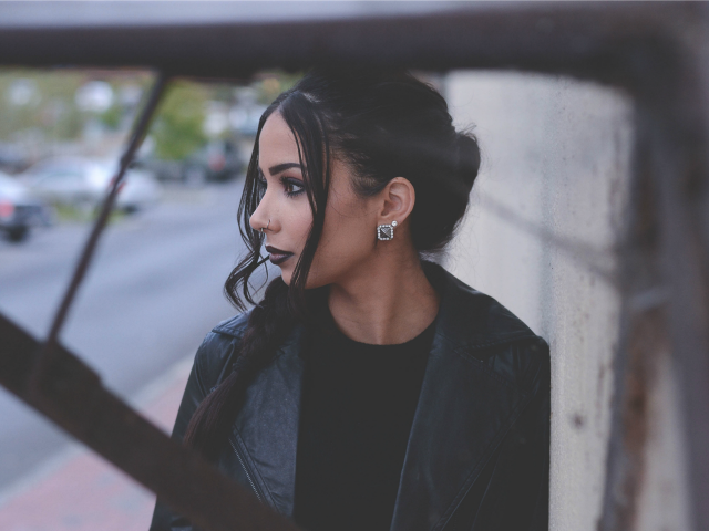brunette woman standing on a walkway