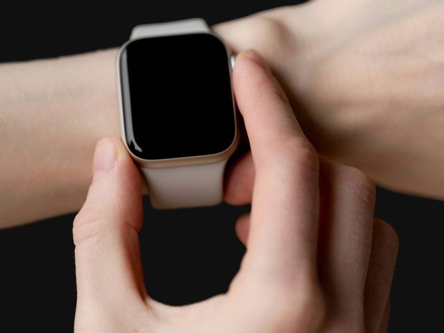 A person uses their wearable smartwatch.