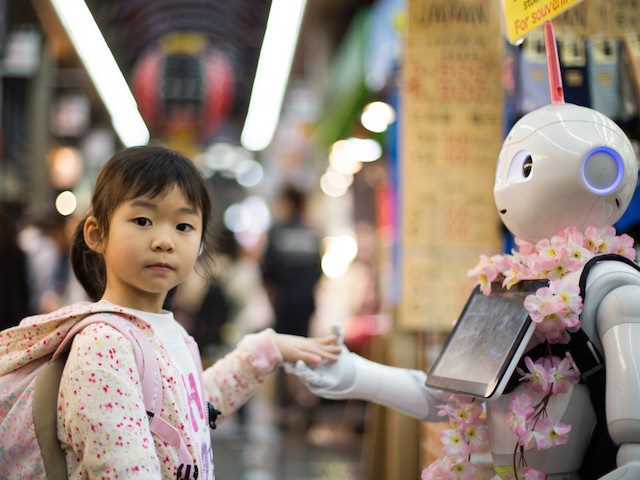 girl with hand in robot's