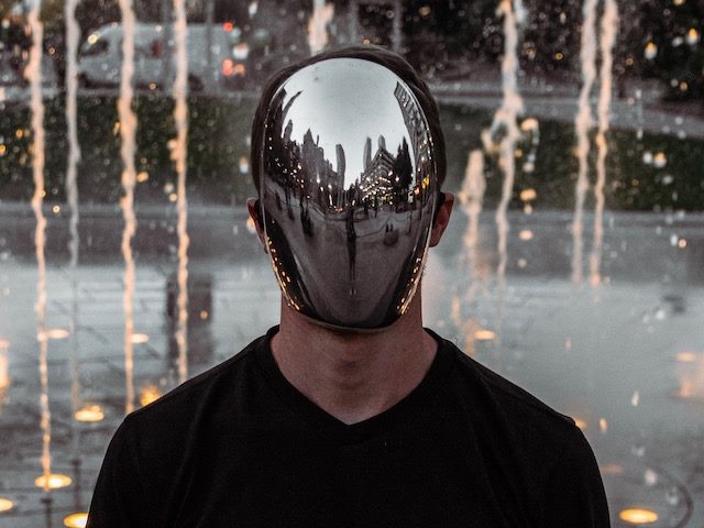 man wearing a mirror mask 