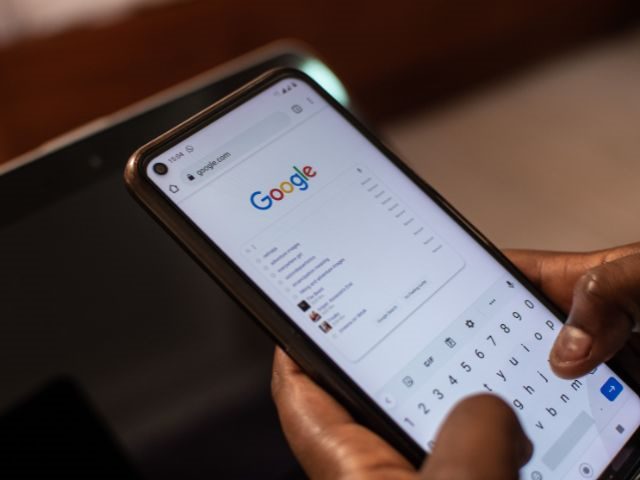 A person using Google Search on a mobile phone 