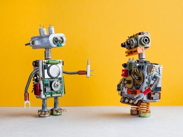 two cute robots meant to suggest automation