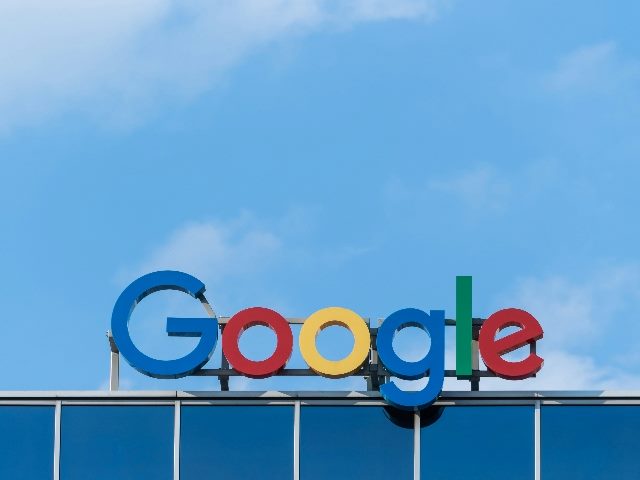 Google logo in the form of letters on top of a building.