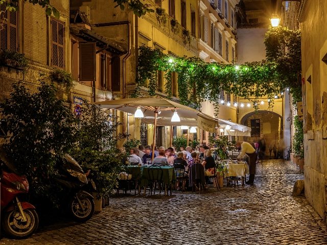 Night view of old street and restaurant in Trastevere in Rome. 