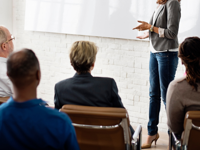 A person teaching a group of people 