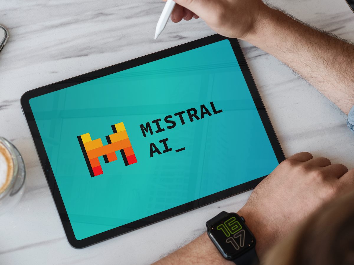 Designer using tablet showing mistral ai logo