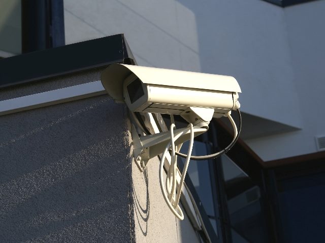 Security camera hanging off building.