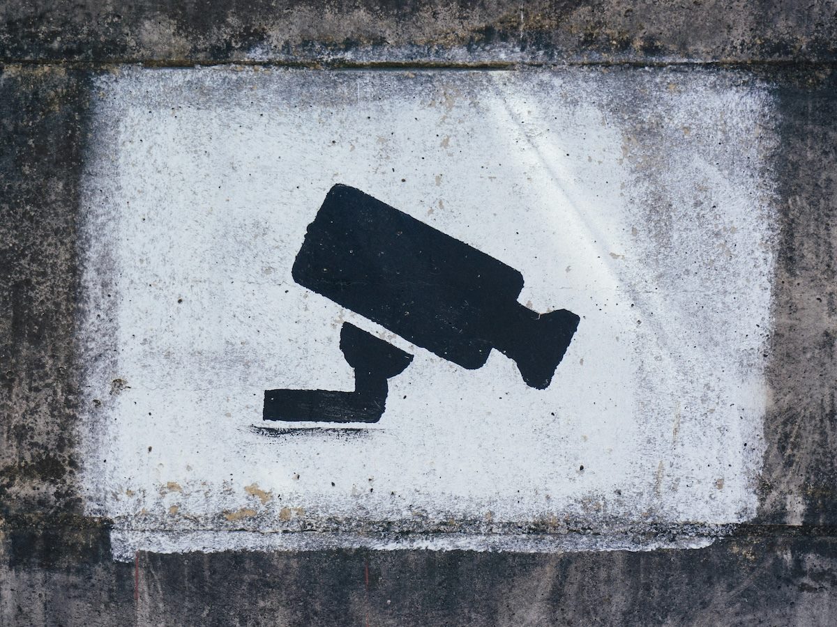 graffiti of a surveillance camera painted on a wall
