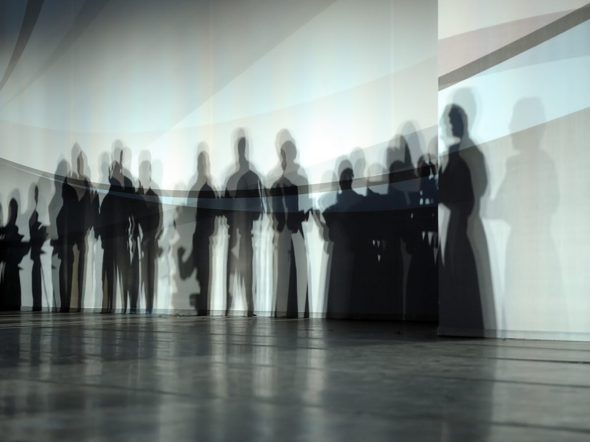 Shadows of a group of people on a wall