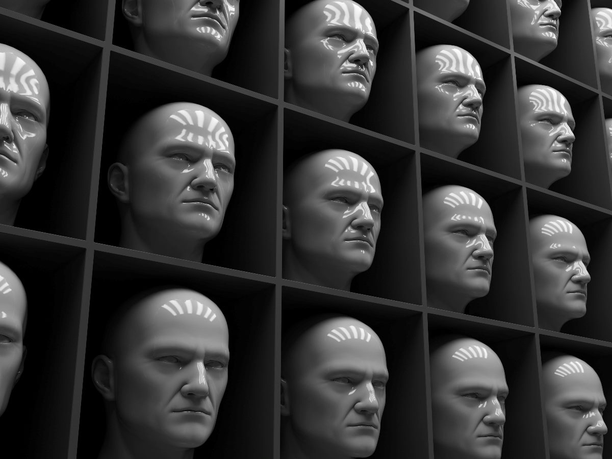 A grid of identical gray human-like heads arranged in uniform rows and columns, symbolizing sameness and lack of individuality, with reflective surfaces and identical expressions.
