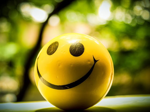 photo of a yellow ball with a smiley face emoji